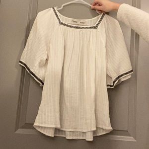 white shirt with black and white trim